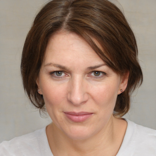 Joyful white adult female with medium  brown hair and brown eyes