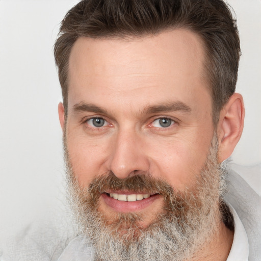 Joyful white adult male with short  brown hair and grey eyes