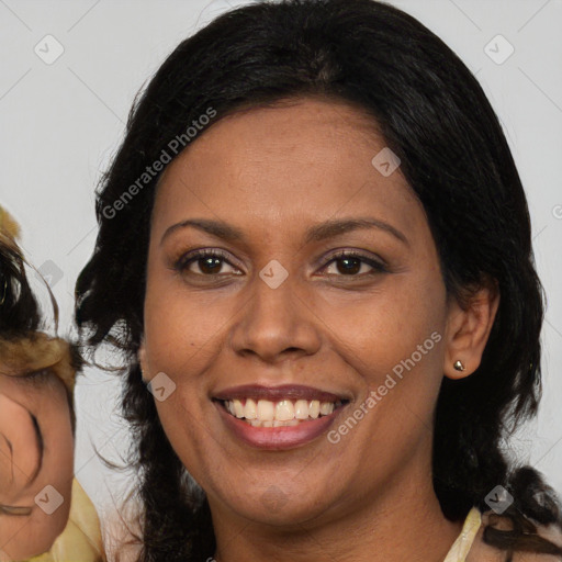 Joyful latino adult female with medium  brown hair and brown eyes