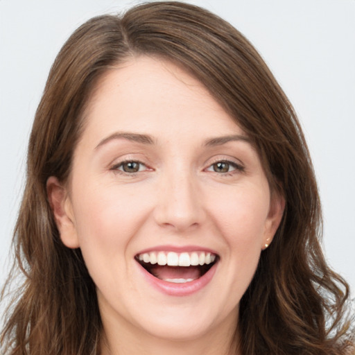 Joyful white young-adult female with long  brown hair and brown eyes