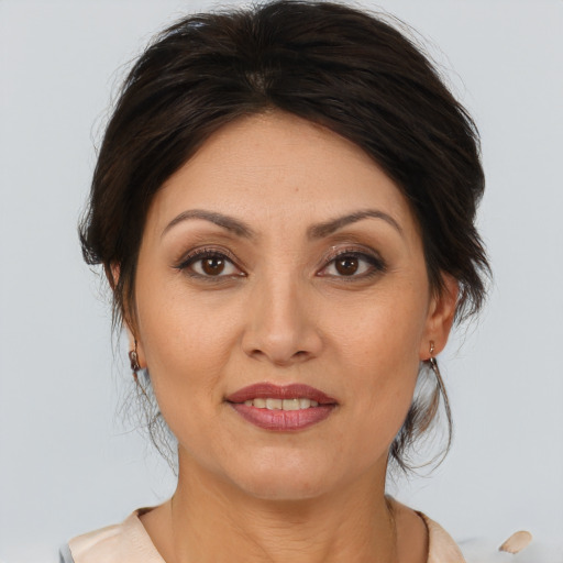 Joyful white adult female with medium  brown hair and brown eyes