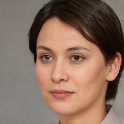 Joyful white young-adult female with medium  brown hair and brown eyes