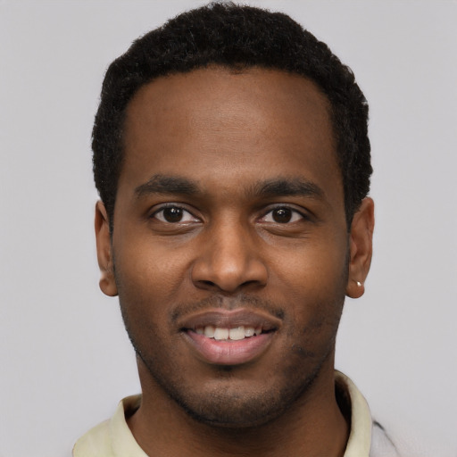 Joyful black young-adult male with short  brown hair and brown eyes