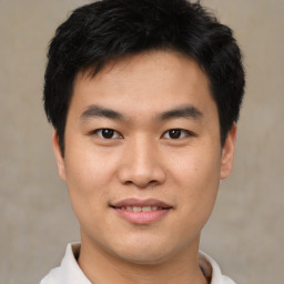 Joyful asian young-adult male with short  black hair and brown eyes