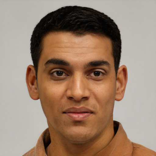Joyful latino young-adult male with short  black hair and brown eyes