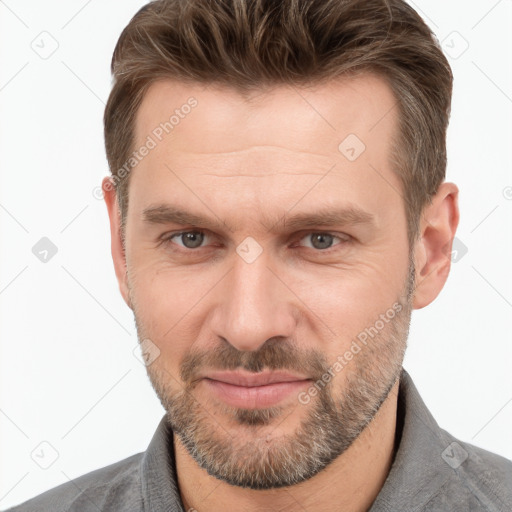 Joyful white adult male with short  brown hair and grey eyes