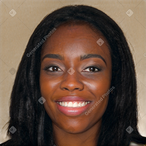 Joyful black young-adult female with long  black hair and brown eyes