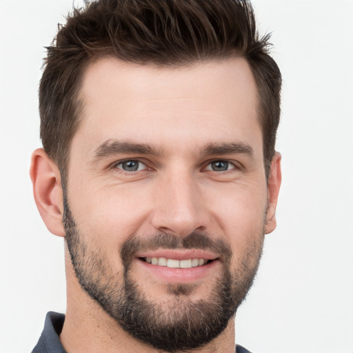 Joyful white young-adult male with short  brown hair and brown eyes