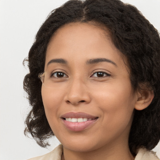 Joyful latino young-adult female with long  brown hair and brown eyes