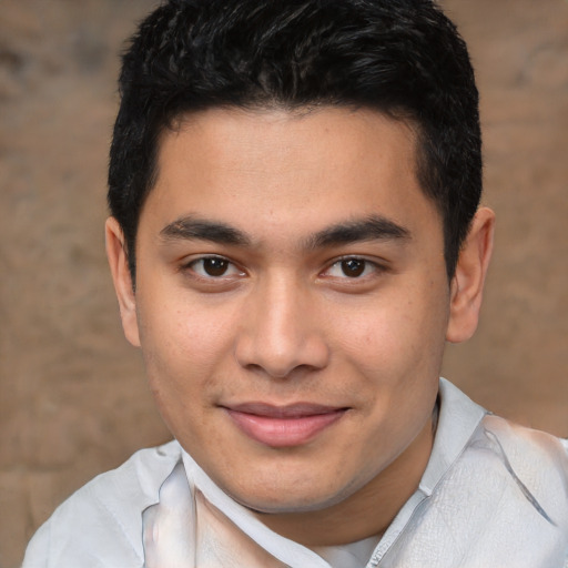 Joyful latino young-adult male with short  brown hair and brown eyes