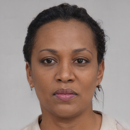 Joyful black adult female with short  brown hair and brown eyes