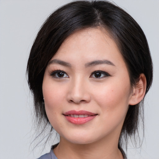 Joyful asian young-adult female with medium  black hair and brown eyes