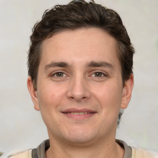 Joyful white adult male with short  brown hair and grey eyes