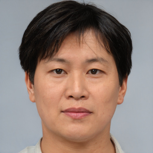 Joyful asian adult male with short  brown hair and brown eyes