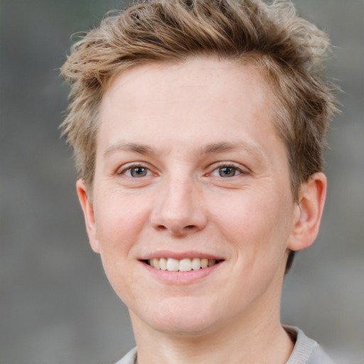 Joyful white young-adult female with short  brown hair and grey eyes