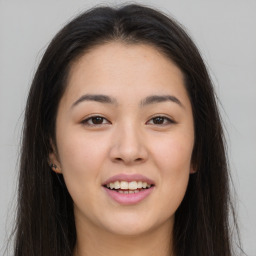 Joyful asian young-adult female with long  brown hair and brown eyes