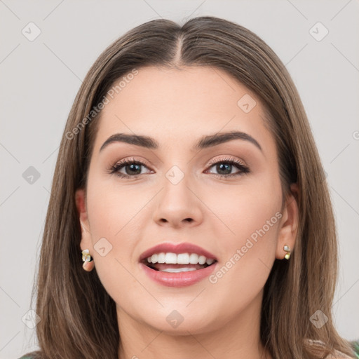 Joyful white young-adult female with long  brown hair and grey eyes