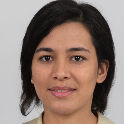 Joyful white adult female with medium  black hair and brown eyes