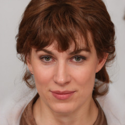 Joyful white young-adult female with medium  brown hair and blue eyes