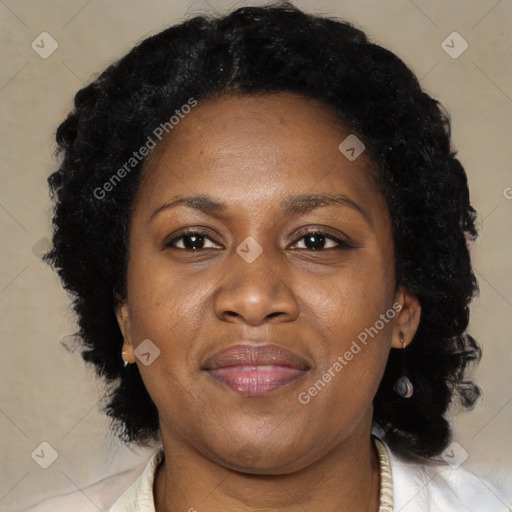 Joyful black adult female with medium  brown hair and brown eyes