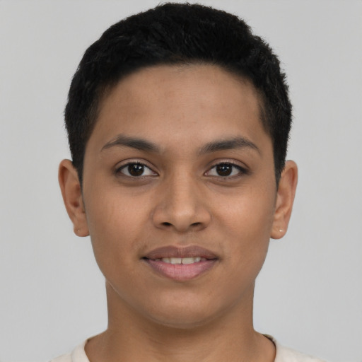 Joyful latino young-adult male with short  black hair and brown eyes