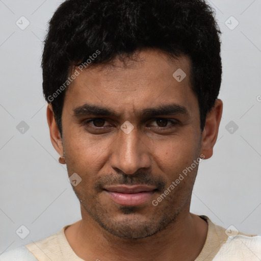Joyful white young-adult male with short  black hair and brown eyes