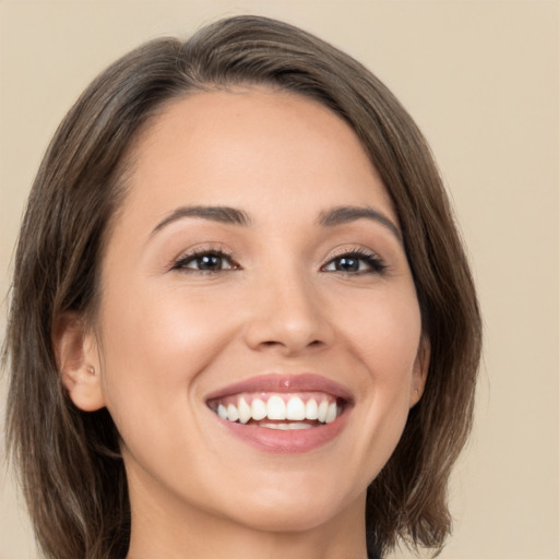 Joyful white young-adult female with medium  brown hair and brown eyes