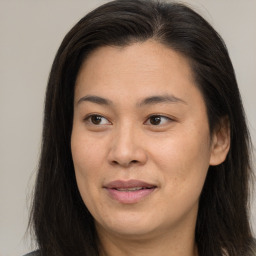 Joyful asian young-adult female with long  brown hair and brown eyes