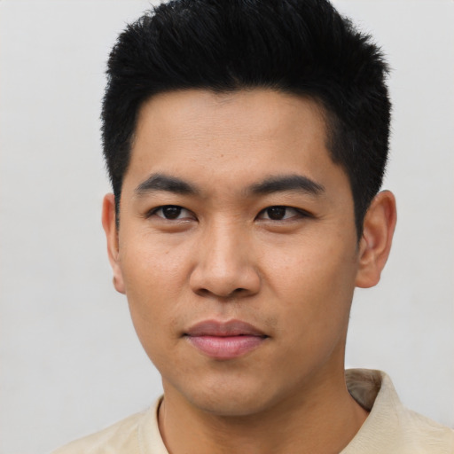 Joyful asian young-adult male with short  black hair and brown eyes
