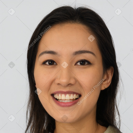 Joyful latino young-adult female with long  brown hair and brown eyes