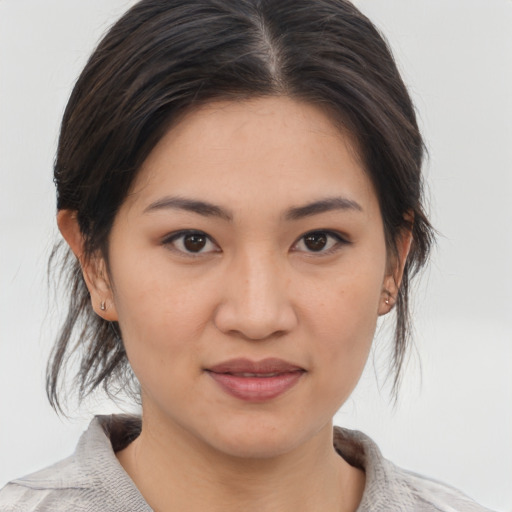 Joyful asian young-adult female with medium  brown hair and brown eyes