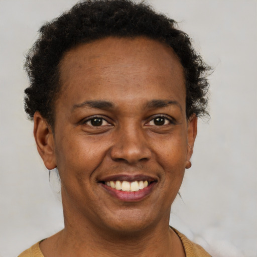 Joyful black adult female with short  brown hair and brown eyes