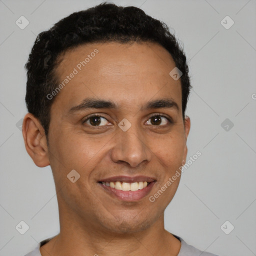 Joyful latino young-adult male with short  brown hair and brown eyes