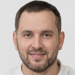 Joyful white adult male with short  brown hair and brown eyes