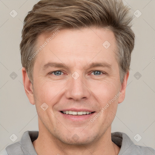 Joyful white adult male with short  brown hair and grey eyes