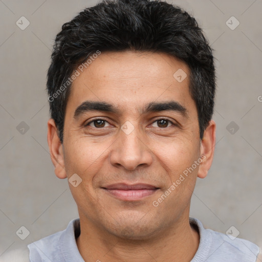 Joyful white adult male with short  black hair and brown eyes