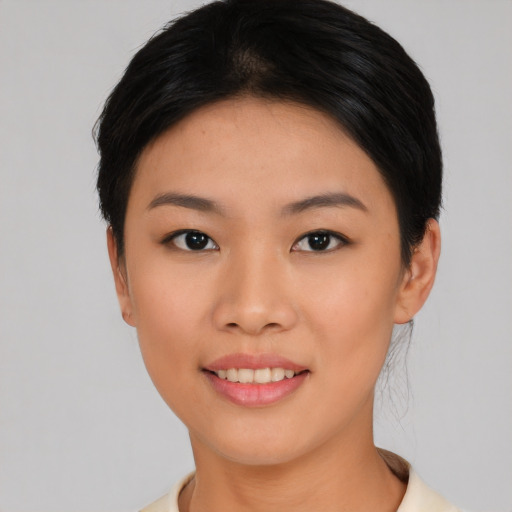 Joyful asian young-adult female with short  black hair and brown eyes