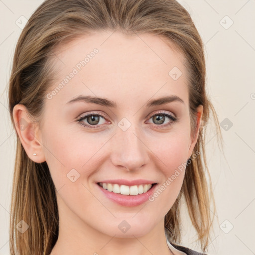 Joyful white young-adult female with long  brown hair and blue eyes