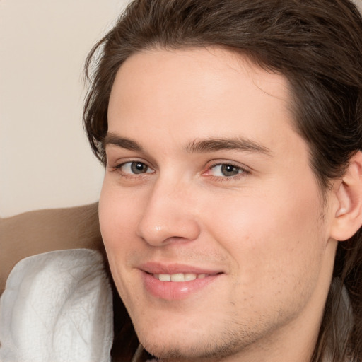 Joyful white young-adult male with medium  brown hair and brown eyes