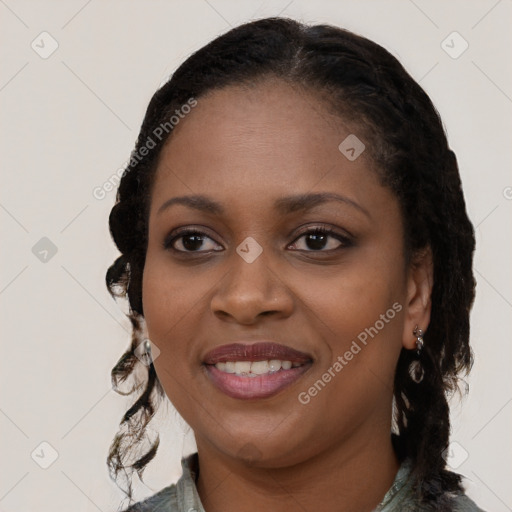 Joyful black young-adult female with long  black hair and brown eyes