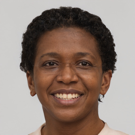Joyful black adult female with short  black hair and brown eyes