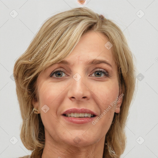 Joyful white adult female with medium  brown hair and blue eyes