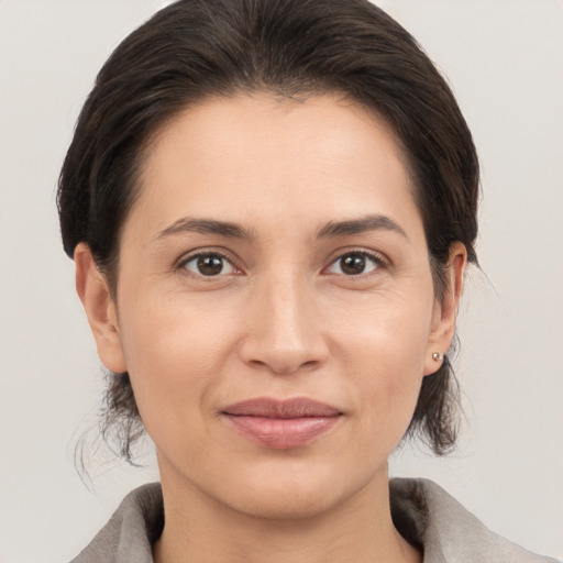 Joyful white young-adult female with medium  brown hair and brown eyes