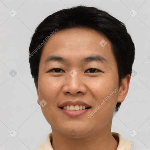 Joyful asian young-adult male with short  black hair and brown eyes