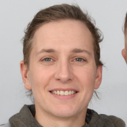 Joyful white adult male with short  brown hair and grey eyes