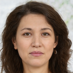 Joyful white adult female with long  brown hair and brown eyes