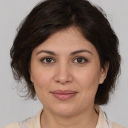 Joyful white adult female with medium  brown hair and brown eyes