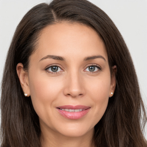 Joyful white young-adult female with long  brown hair and brown eyes