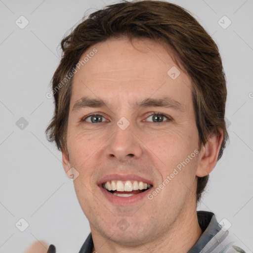 Joyful white adult male with short  brown hair and grey eyes