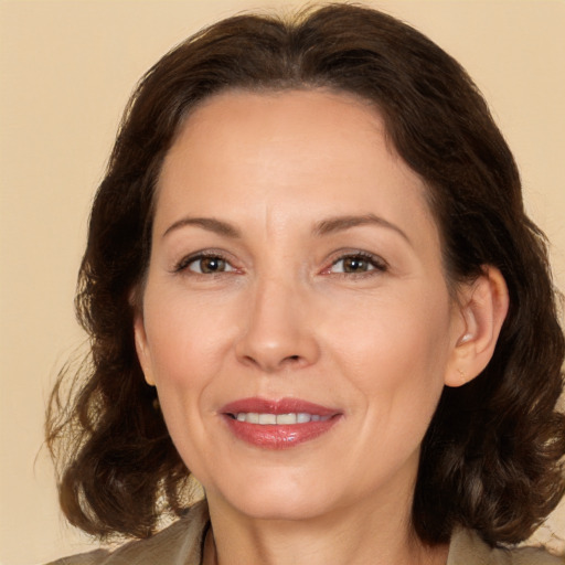 Joyful white adult female with medium  brown hair and brown eyes